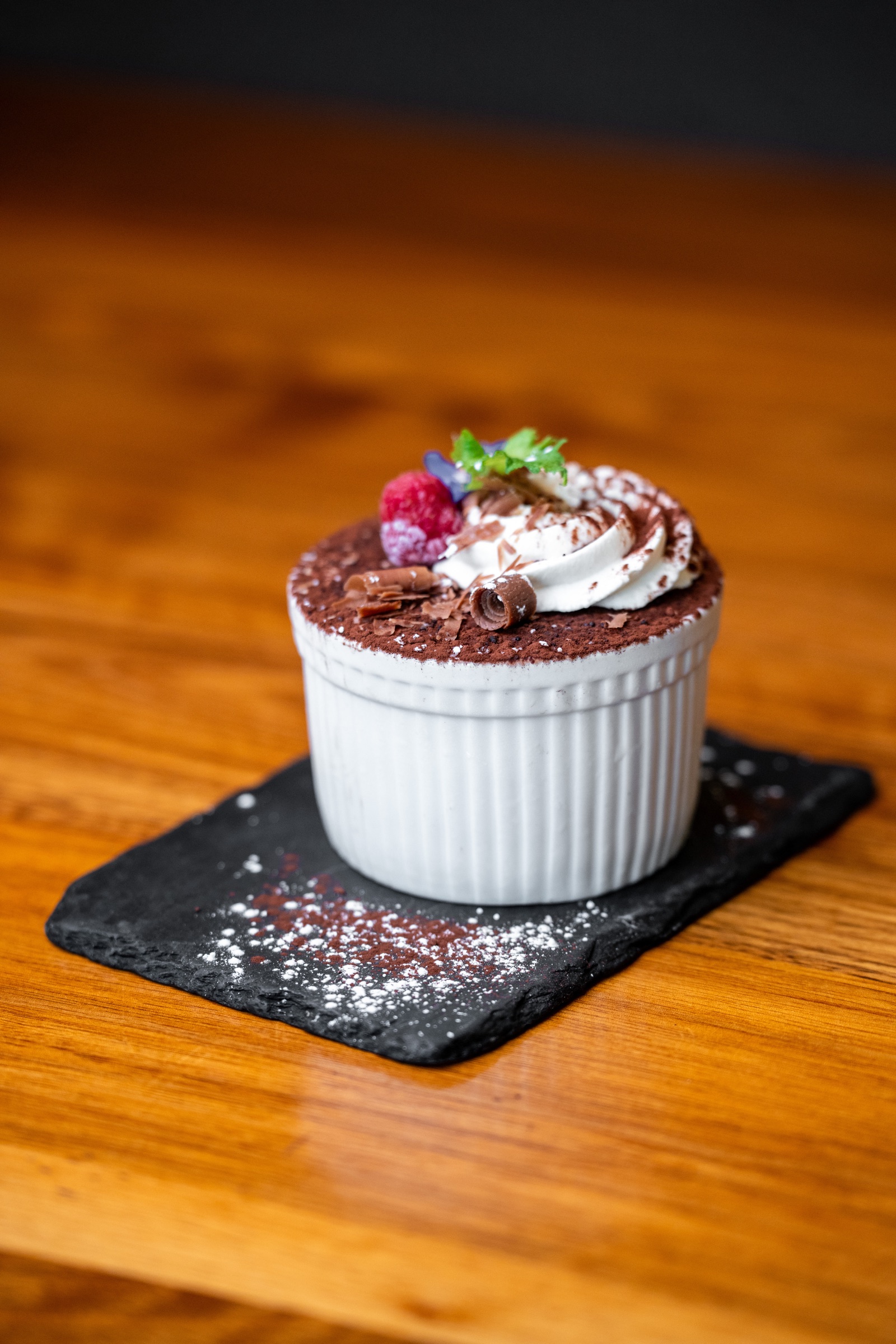 Chocolate dessert topped with cream and berries